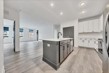 A modern kitchen with a large island and stainless steel appliances at Luxe 360 on Centerpointe Apartments, Midlothian, VA